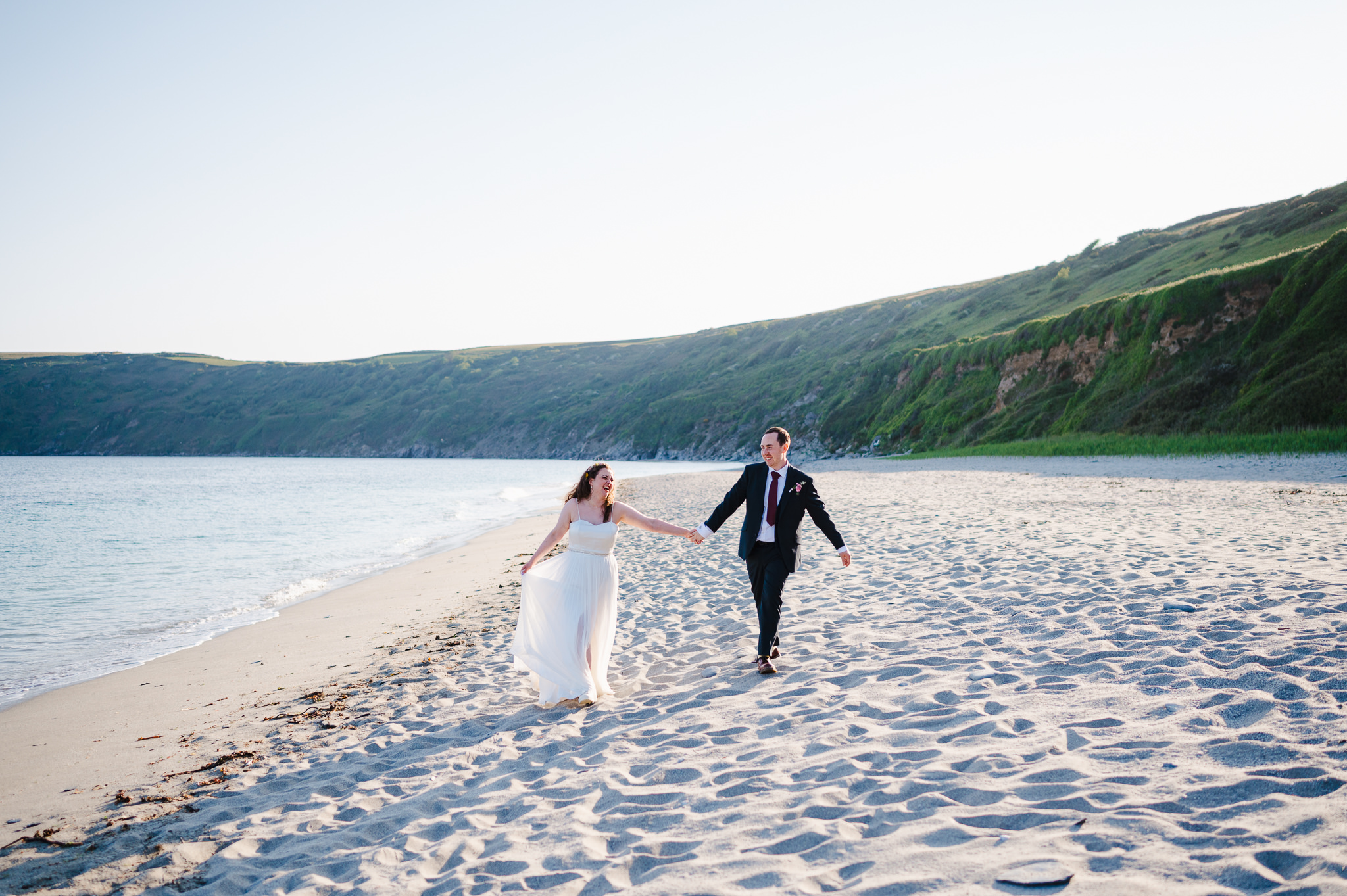 Happy couple take a stroll through the sandy beach