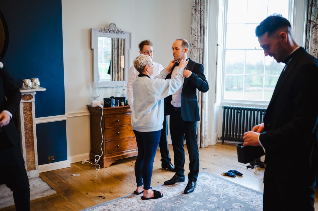 Groom and his party getting ready to celebrate the grooms wedding at Rockbeare Manor