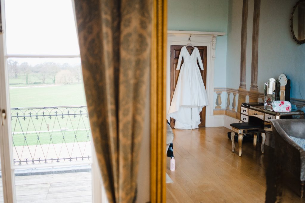 Looking into a mirror at wedding dress